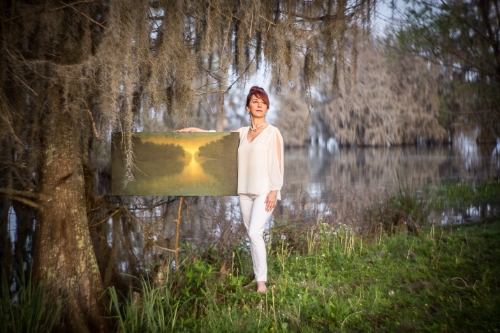Artist Melissa Bonin with one of her paintings at Lake Martin, Louisiana in 2015. Through many days of research and conversations we knew we had to be at the lake one hour before sunrise to be setup and ready for the magic of the morning